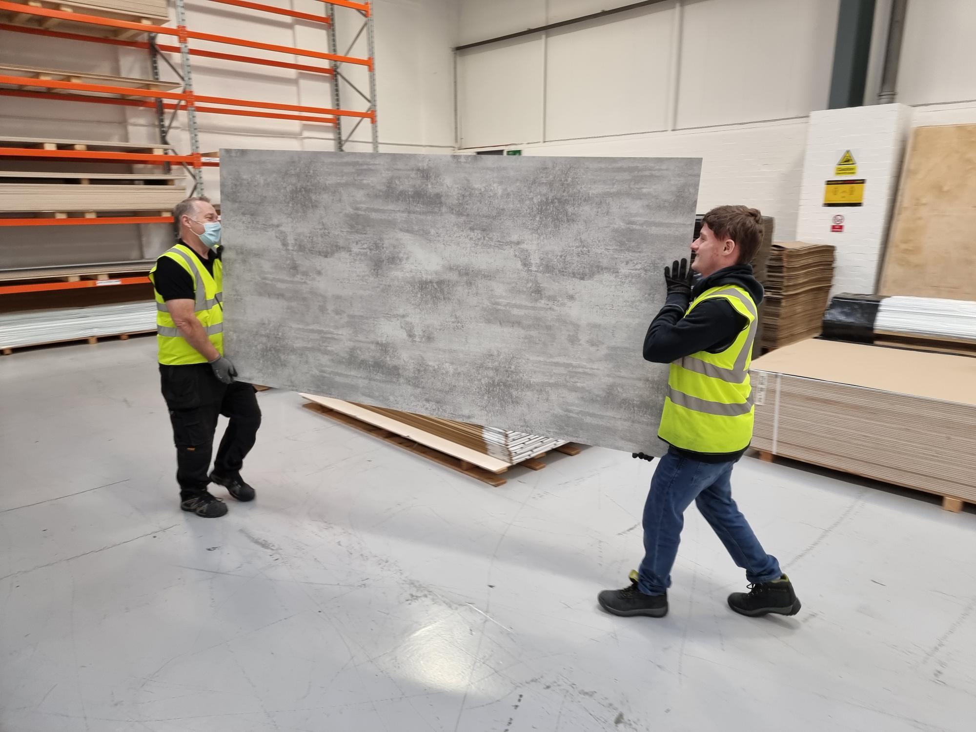 Perform Panel Wet Wall Panels being handled by two members of the Donaldson Group