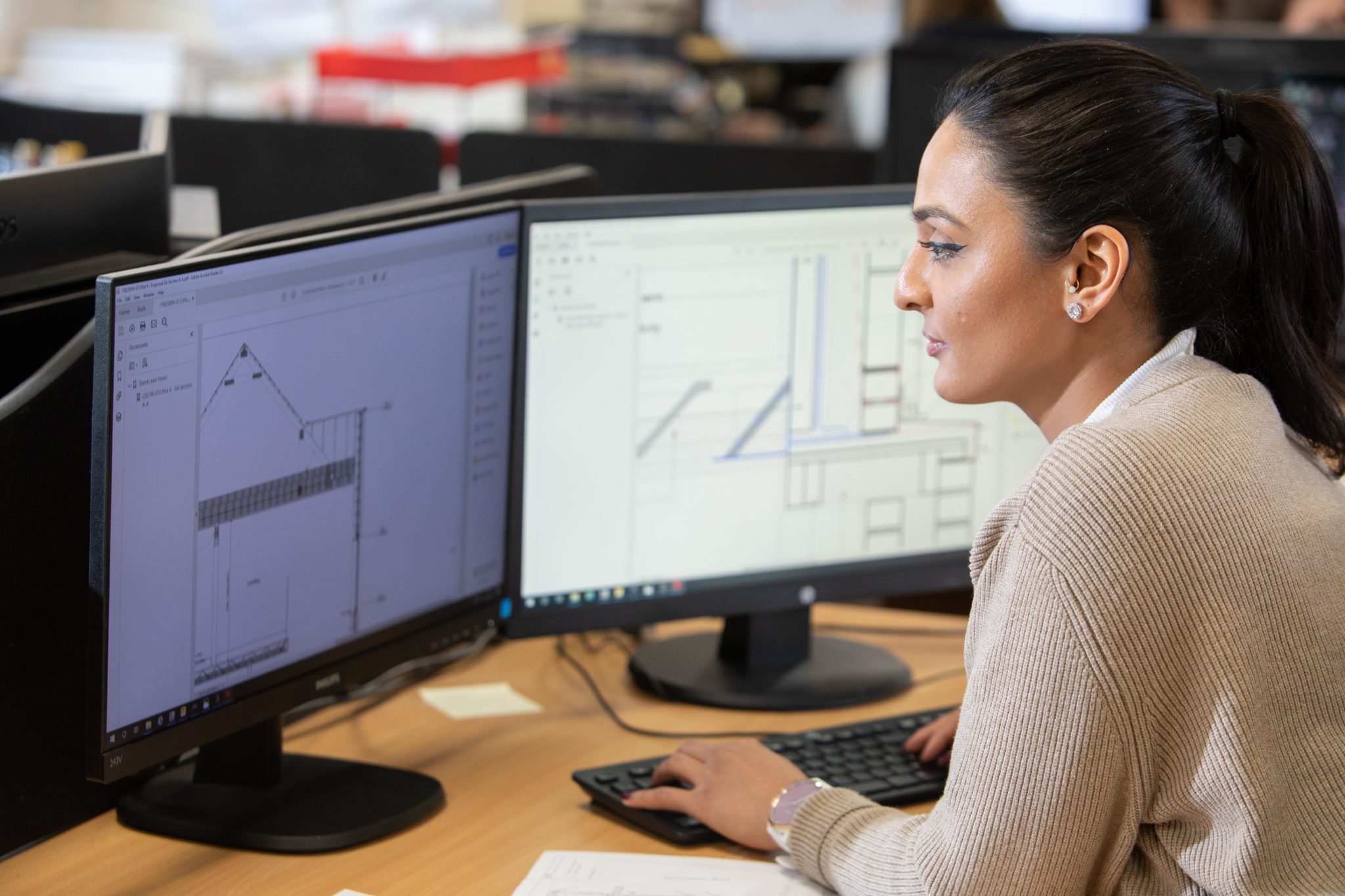 A Donaldson Group employee working at her desk in front of two monitors